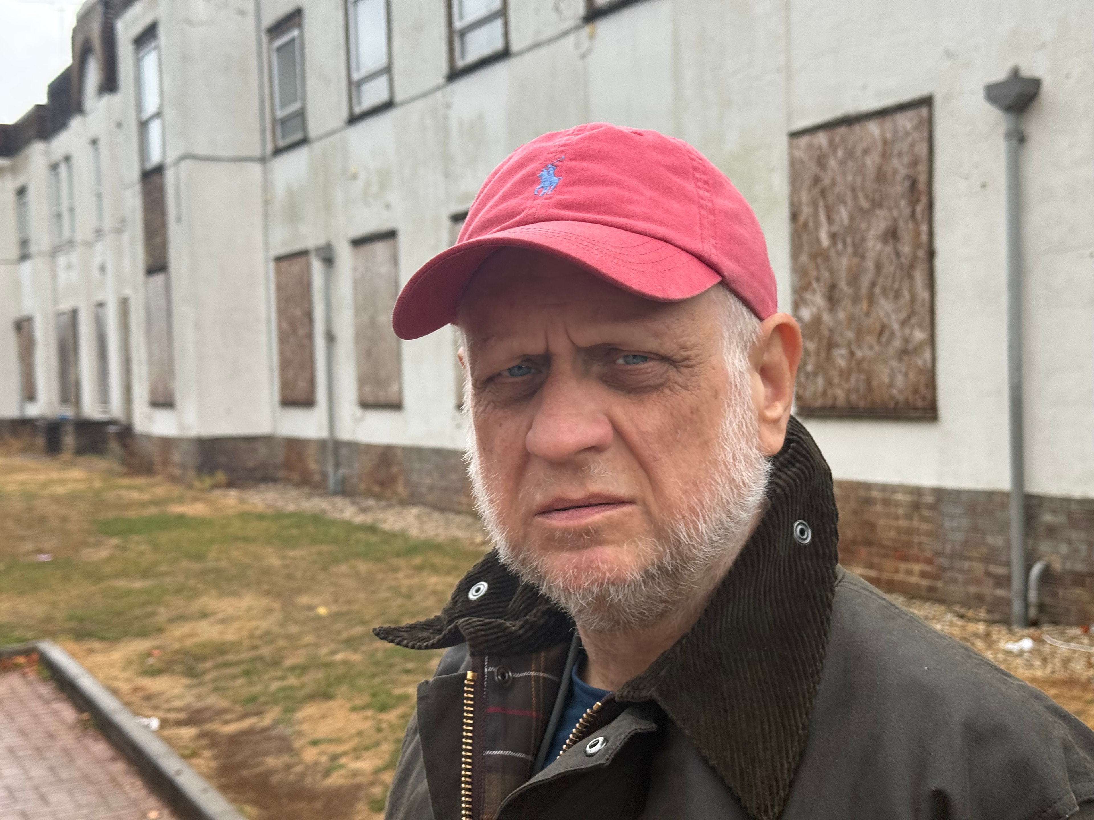 Paul-Austin Sargent outside boarded-up buildings at Horton General Hospital